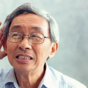 Close-Up of Elderly Male Has Hearing Problem Cupping His Ear