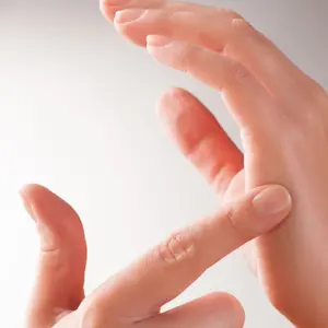 Woman doing Emotional Freedom Techniques (EFT) tapping on the karate chop point.