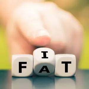 Hand turns dice and changes the word "fat" to "fit"