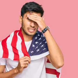 Young handsome man holding united states flag stressed