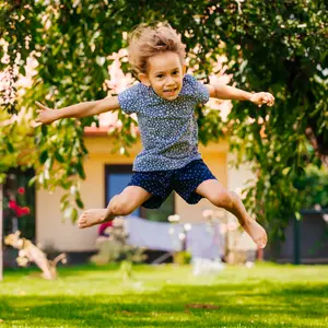 Active little girl has fun in the backyard