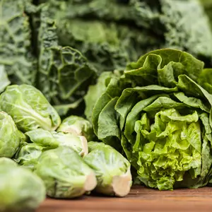 Assortment of green vegetables on wooden surface