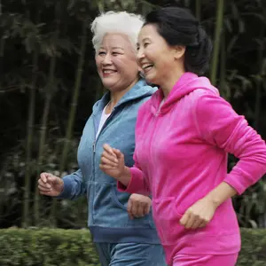 Two older women jogging together