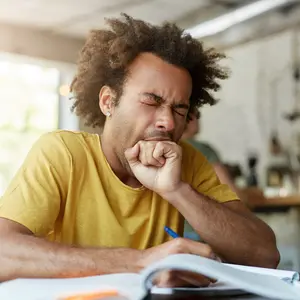 Exhausted sleepy black European man yawning