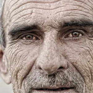 Mature man with wrinkles, close up portrait
