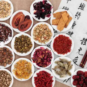 Traditional chinese herbal medicine with mandarin calligraphy on rice paper. Translation describes the medicinal functions to maintain body and spirit health and balance energy.