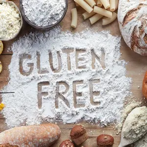 Gluten free food. Various pasta, bread, snacks and flour on wooden background from top view