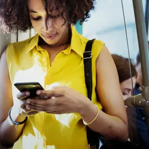 Young woman using a smartphone in a subway