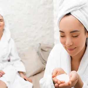 Halotherapy. Salt therapy. Portrait Asian woman with towel on her head, enjoying during treatment in a salt room at a spa. 
