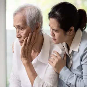 Loving daughter embracing comforting and consoling senior woman