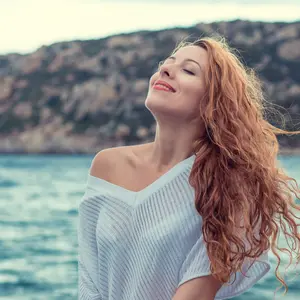 Woman on the beach enjoying fresh air