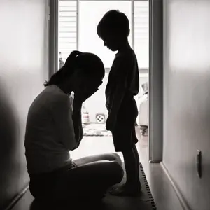 Depressed mother crying next to her child. Depressed mother crying next to her child.