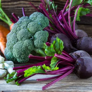 Fresh vegetables beetroots, broccoli, carrots, green onion on wooden background