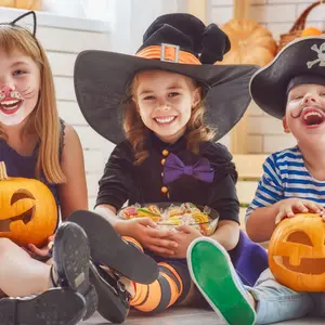 Happy brother and two sisters on Halloween.