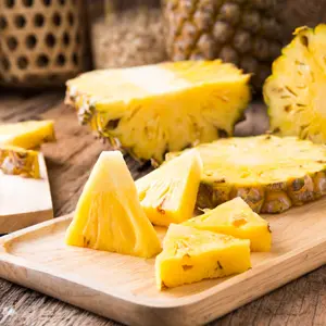 Cut pineapple on the wooden background