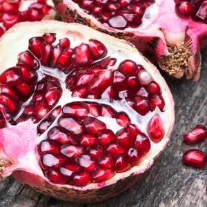 Juicy pomegranates on wood