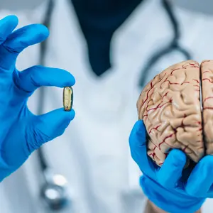 Placebo Effect Concept. Female doctor holding model of brain and placebo supplement pill