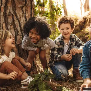 Cute children playing in woods