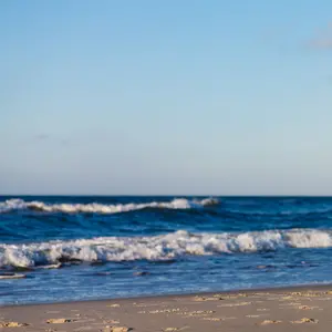 Middle-aged woman running on beach