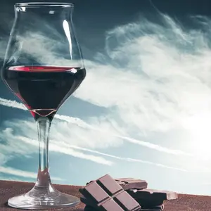 Wine glass and chocolate with blue cloudscape