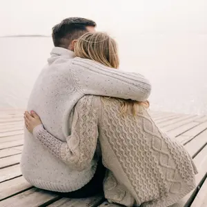 Couple embracing at the water