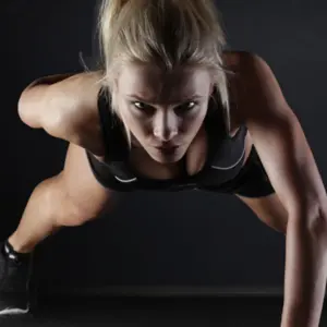 Woman doing one arm pushup Woman doing one arm pushup