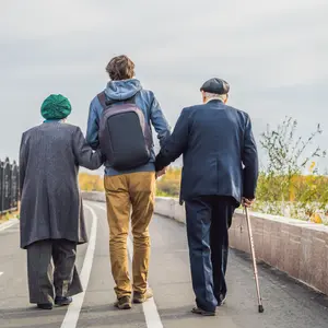 Helping an elderly couple walk in the park
