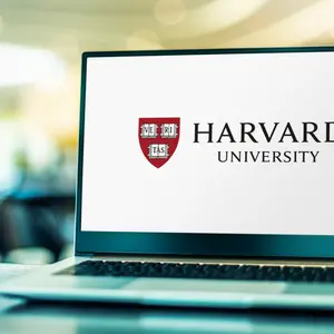 Laptop computer displaying logo of Harvard University