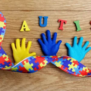 Autism awareness concept with colorful hands on wooden background. Autism awareness concept with colorful hands on wooden background.