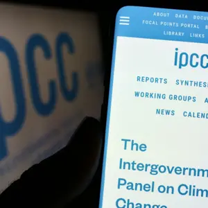 Person holding cellphone with website of Intergovernmental Panel on Climate Change (IPCC) on screen with logo Person holding cellphone with website of Intergovernmental Panel on Climate Change (IPCC) on screen with logo