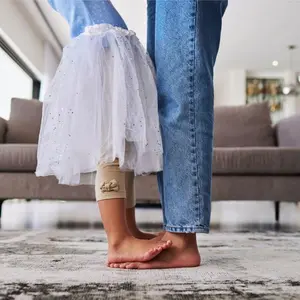 Mother dancing with daughter standing on her feet