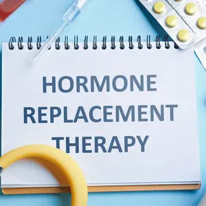 Notebook with text Hormone Replacement Therapy and medications on light blue background Notebook with text Hormone Replacement Therapy and medications on light blue background