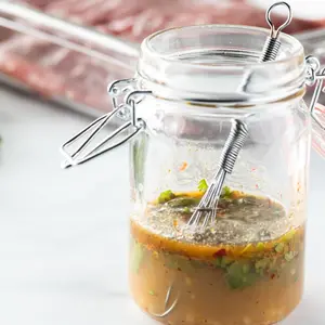 Close up of a small jar filled with a marinade mixture