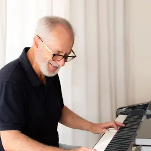 Man learning to play piano