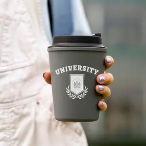 Woman holding a cup that says University