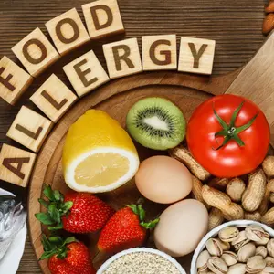 Allergy food concept. Allergy food as almonds, milk, pistachios, tomato, lemon, kiwi, trout, strawberry, bread, sesame seeds, eggs, peanuts and bean on wooden table