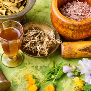 Natural medicine herbs, bowls on green table cloth