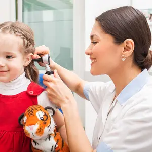 Doctor performing ear exam