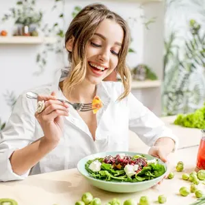 Smiling woman sitting down to eat Smiling woman sitting down to eat