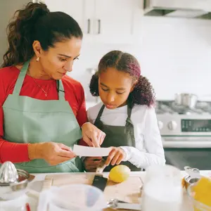 Mother and daughter cooking together