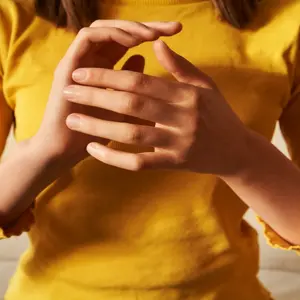 Woman practicing EFT tapping technique using her hands Woman practicing EFT tapping technique using her hands