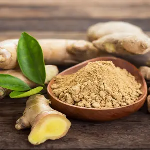 Ginger root and ginger powder in a bowl