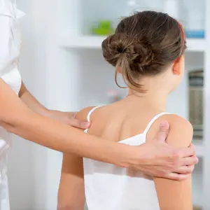Chiropractor doing adjustment on young female pediatric patient