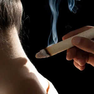 Person receives moxibustion to the back of their neck