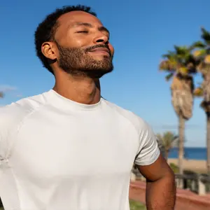 African American man breathing deeply in nature, relaxation and calm