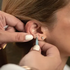 Woman receiving auricular acupressure