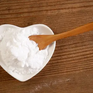 Backing soda in a heart-shaped bowl and wooden spoon