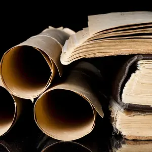 Many scrolls and old books on black background