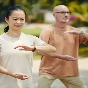 mature woman and man practicing tai chi