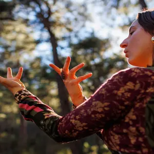 woman in forest dancing solo